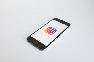 Instagram logo on phone for Houston social media marketing