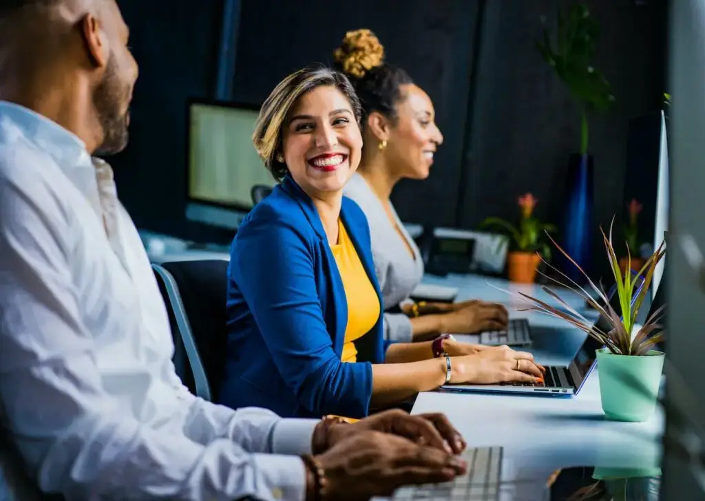 Woman smiling while working with team to create Houston PPC campaign