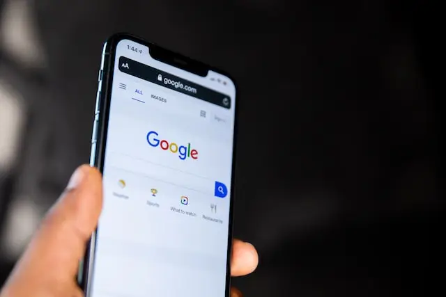 Person on phone searching through Google to show how Houston search engine optimization improves rankings.